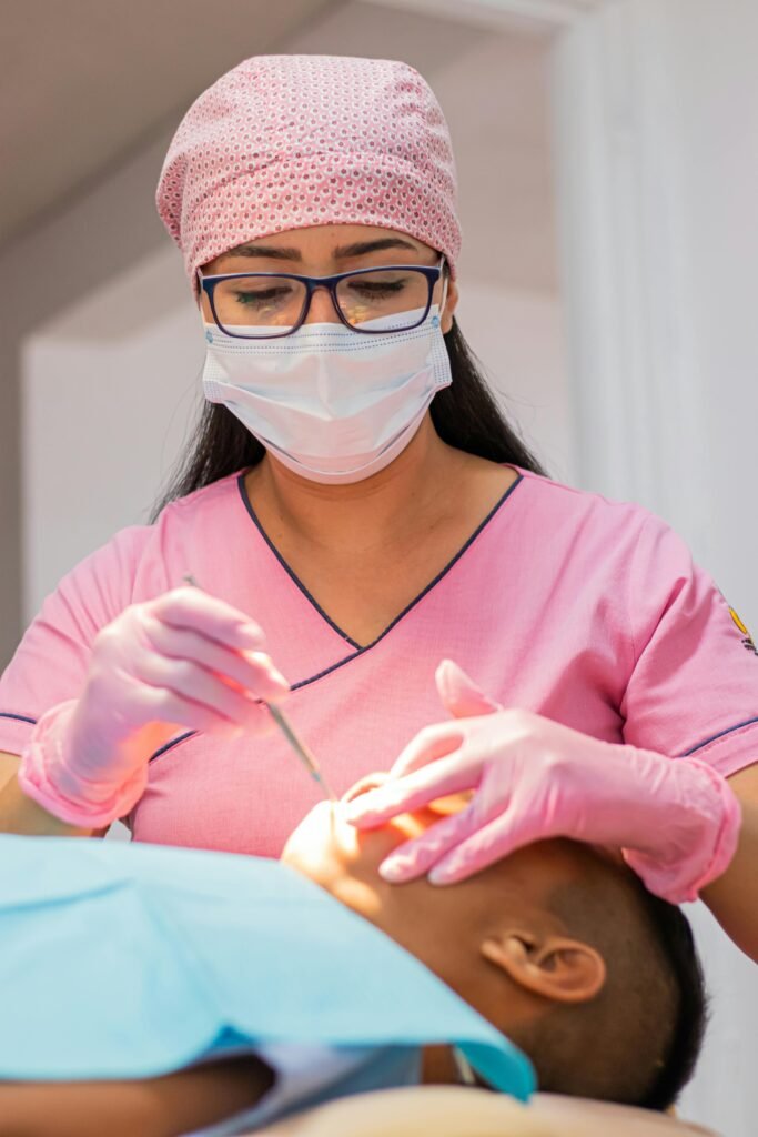 Dentist Looking into the Mouth of a Patient